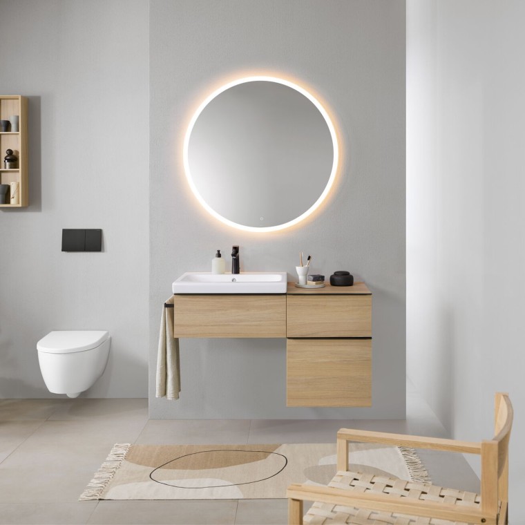 Bathroom with grey walls, Geberit bathroom furniture in wood and a round Geberit Option illuminated mirror Bathroom with grey walls, Geberit bathroom furniture in wood and a round Geberit Option illuminated mirror