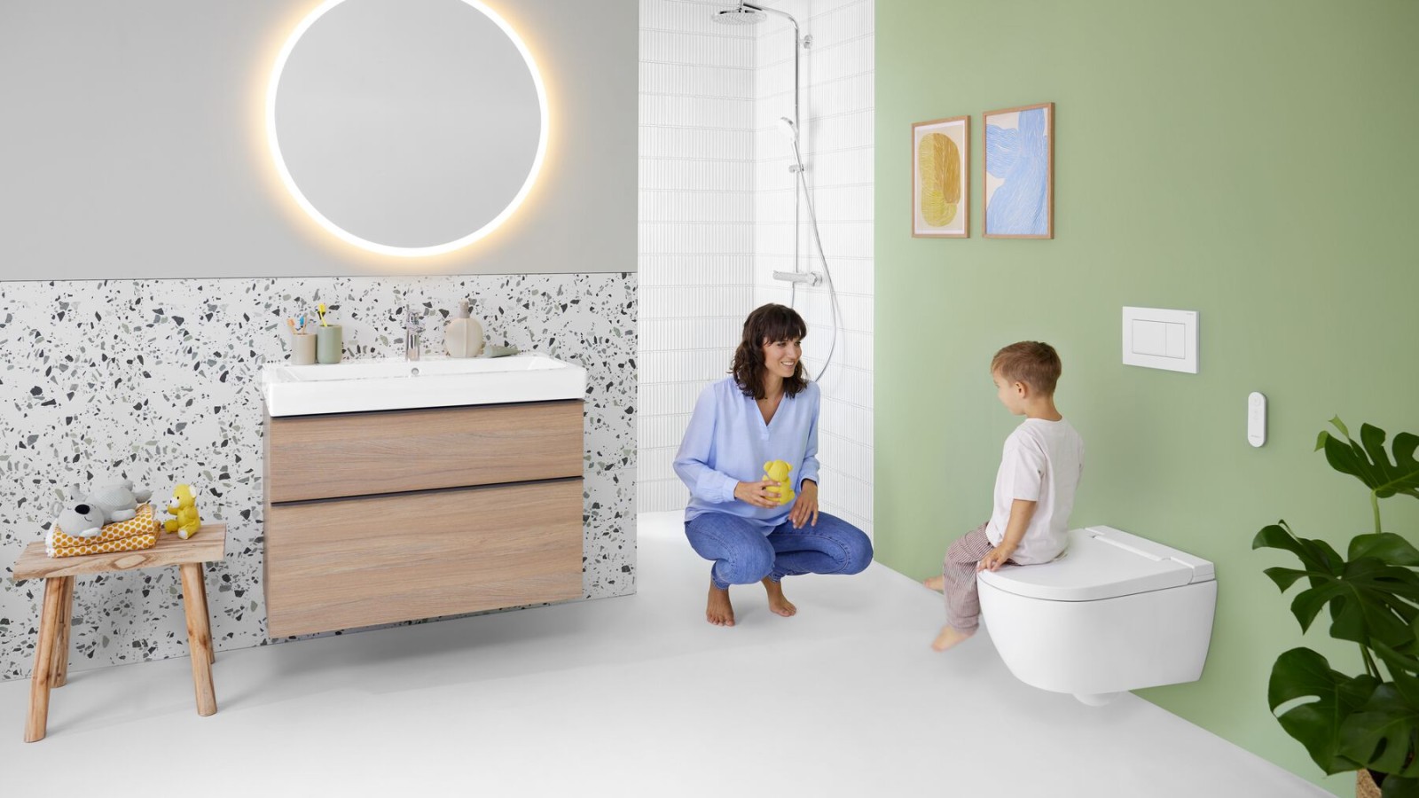 Woman and child in a bathroom with a Geberit AquaClean Alba shower toilet Woman and child in a bathroom with a Geberit AquaClean Alba shower toilet