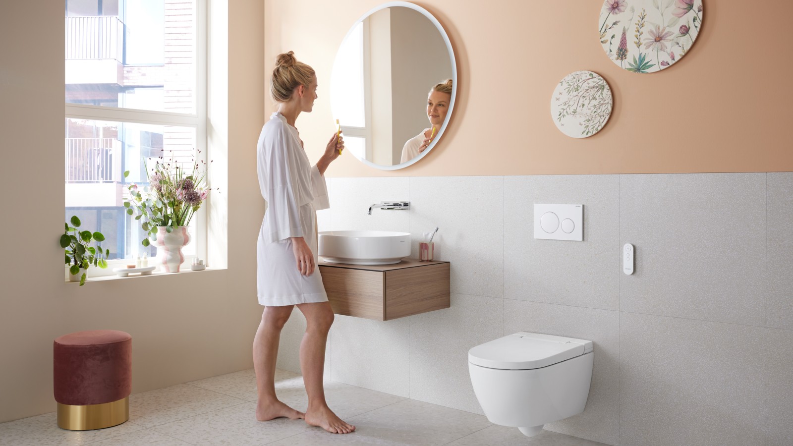 Woman in bathroom with Geberit AquaClean Alba - a cost-effective bidet toilet spray functionality