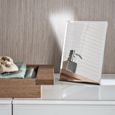 A soap dispenser reflected in a small decorative mirror