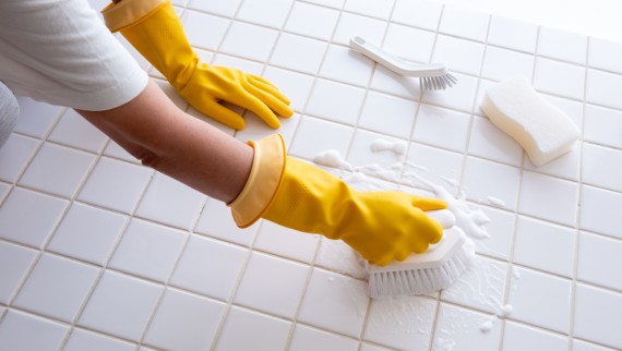 Woman scrubbing bathroom floor