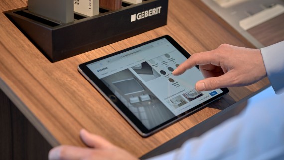 Man with tablet selects products in a configurator