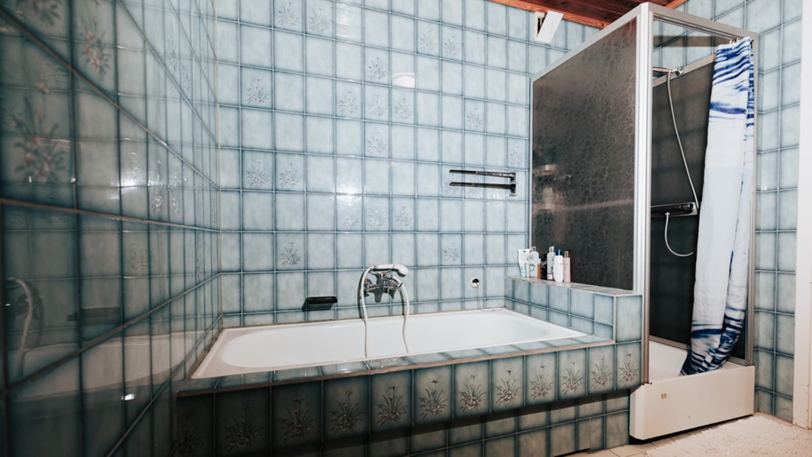 Bathroom with blue tiles, shower cubicle and bathtub Bathroom with blue tiles, shower cubicle and bathtub